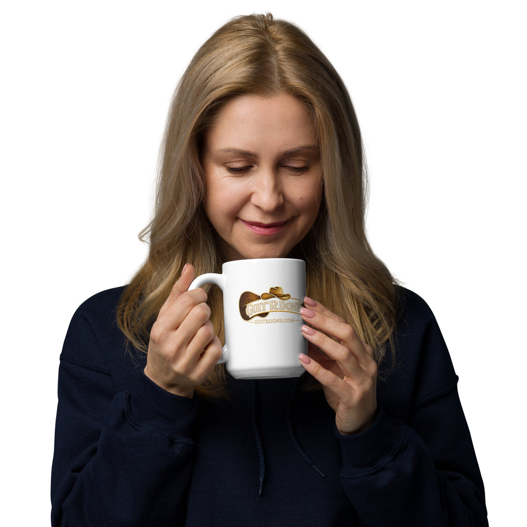 Woman holding Guit'R Done white glossy coffee mug 15 oz with guitar and cowboy hat logo